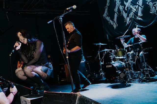 Perrish 9 on stage under blue lighting