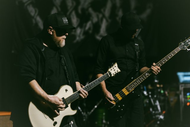 Two guitarists performing together