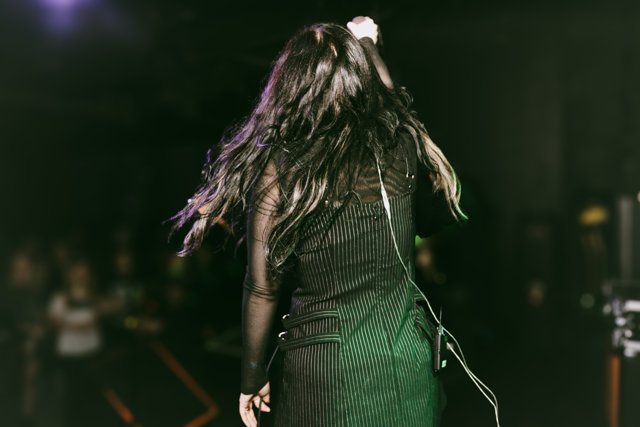 Sarah facing the stage with her hair in motion