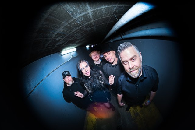 The band leaning toward the camera backstage