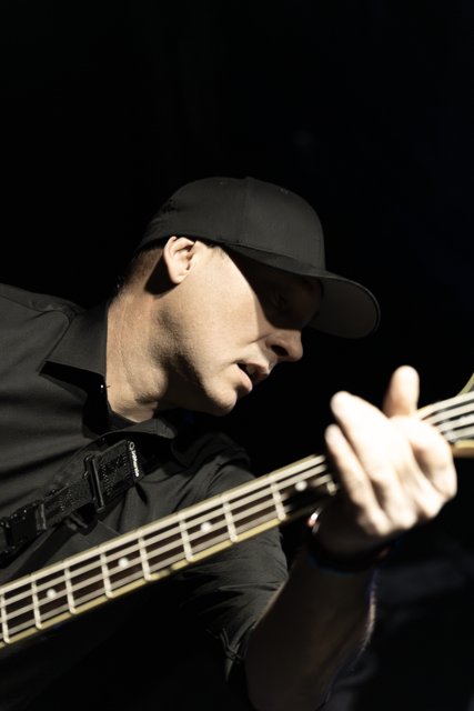 A guitarist concentrating on his instrument