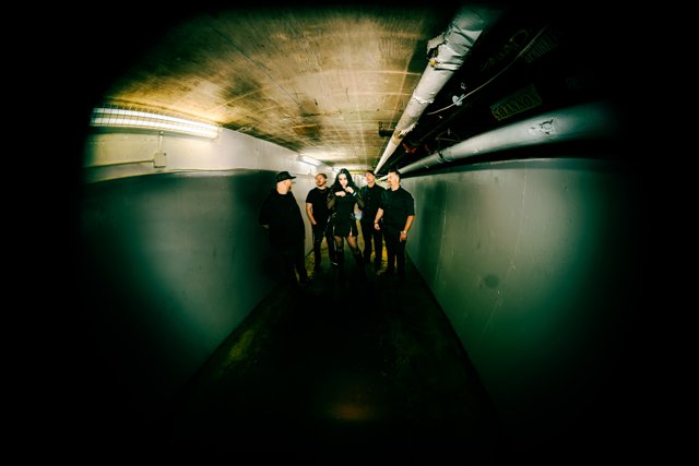 The band posing at the far end of the corridor