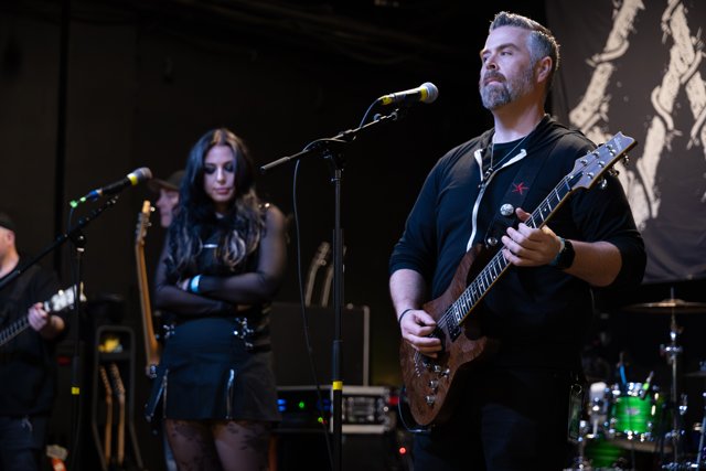Sarah and a guitarist performing side by side