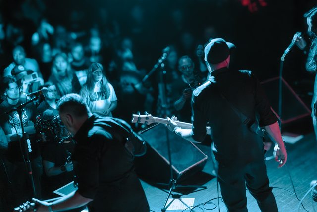 The band performing from a view near the stage