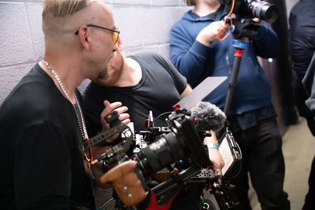A camera operator filming backstage