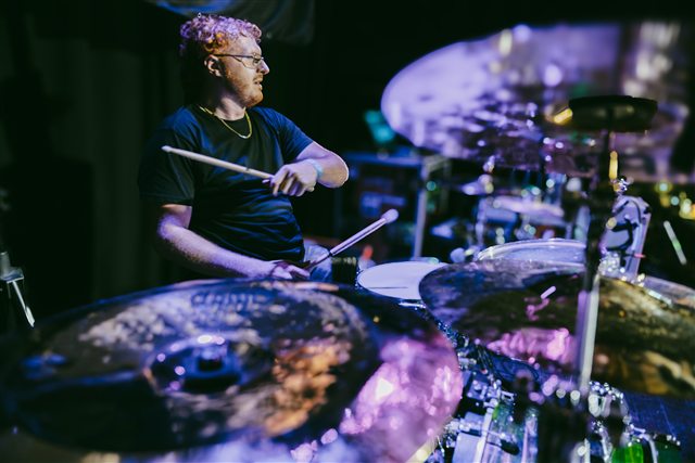 The drummer performing behind the kit