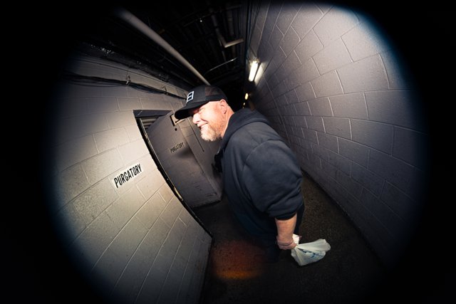 A band member walking through the venue corridor