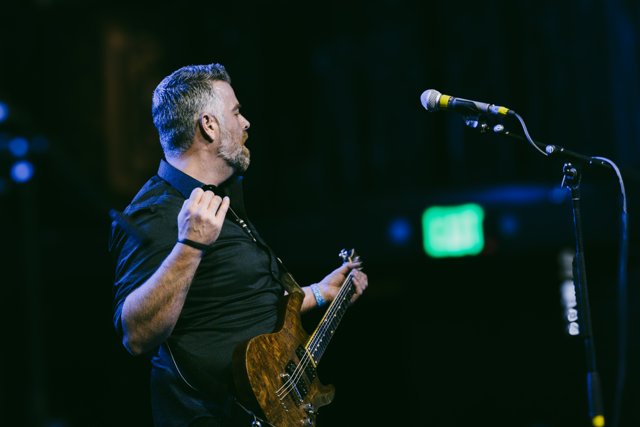 A guitarist looking across the stage