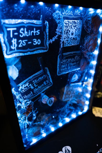 The merch display illuminated with blue lights