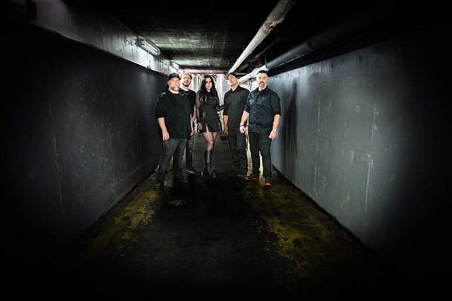 The band together in a dark corridor
