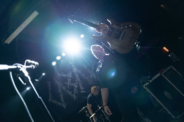 Sarah performing beneath a bright white stage light