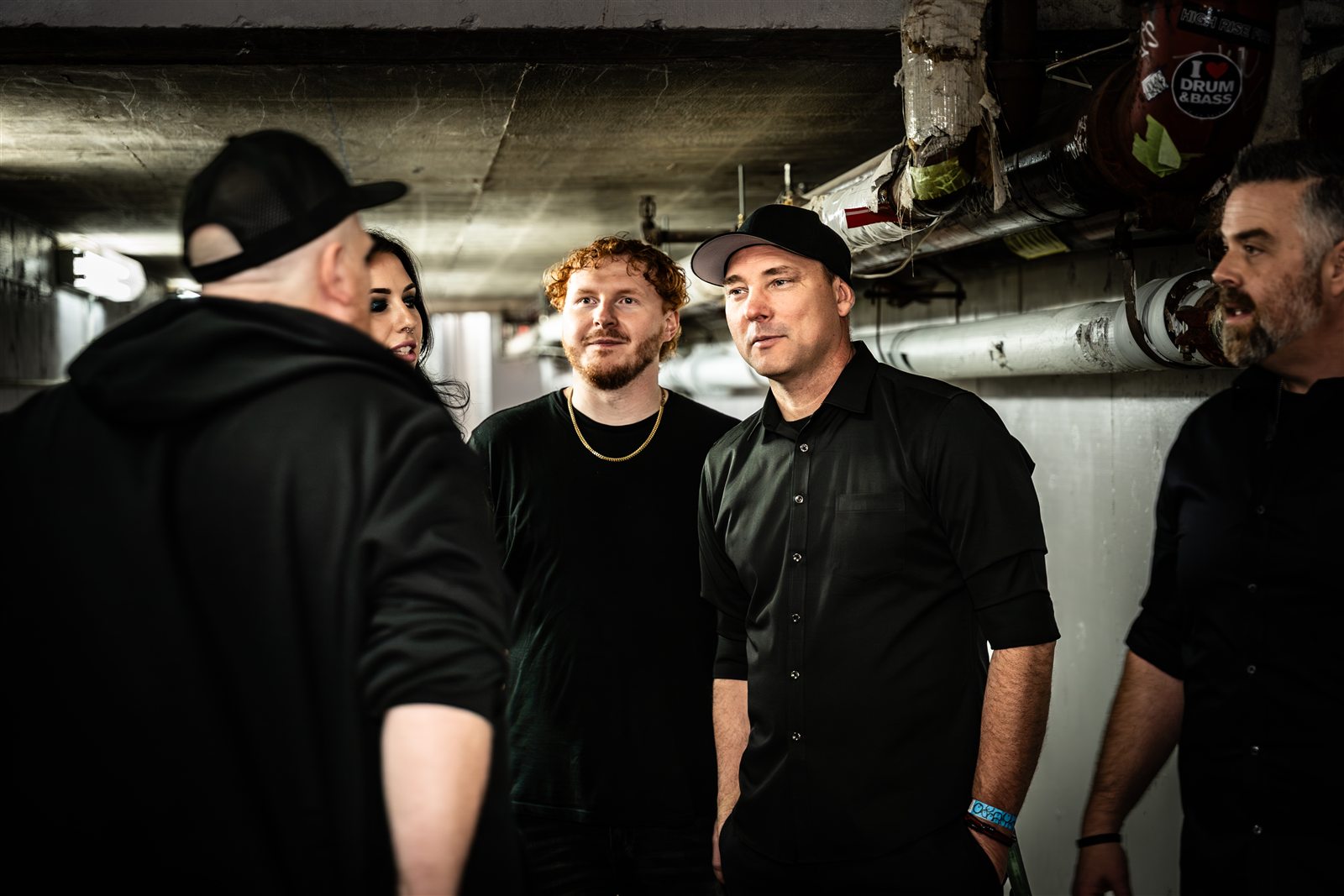 Band members sharing a candid conversation backstage