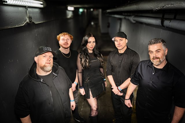 The band posing together in a backstage corridor