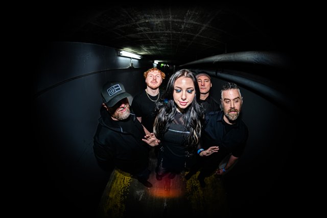 The band gathered beneath dim corridor lights