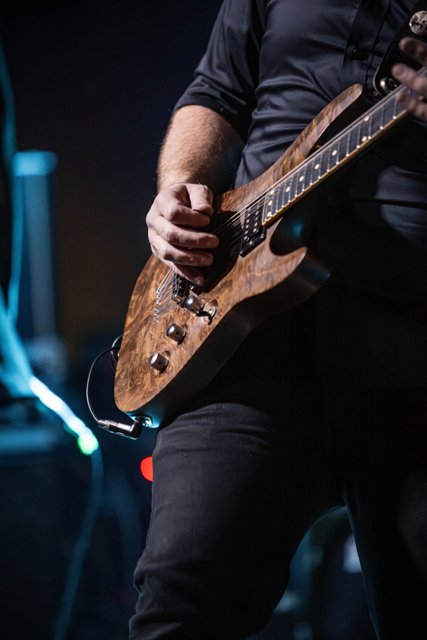 A close view of a guitarist playing his instrument