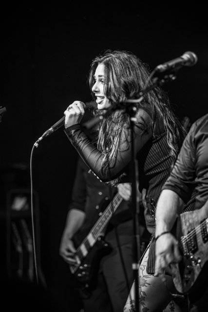 Sarah leaning toward the crowd in black and white