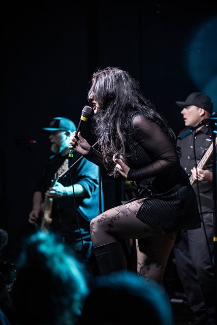 Sarah singing at the front of the stage