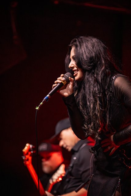 Sarah singing beside the microphone stand
