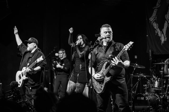 The band performing together in black and white